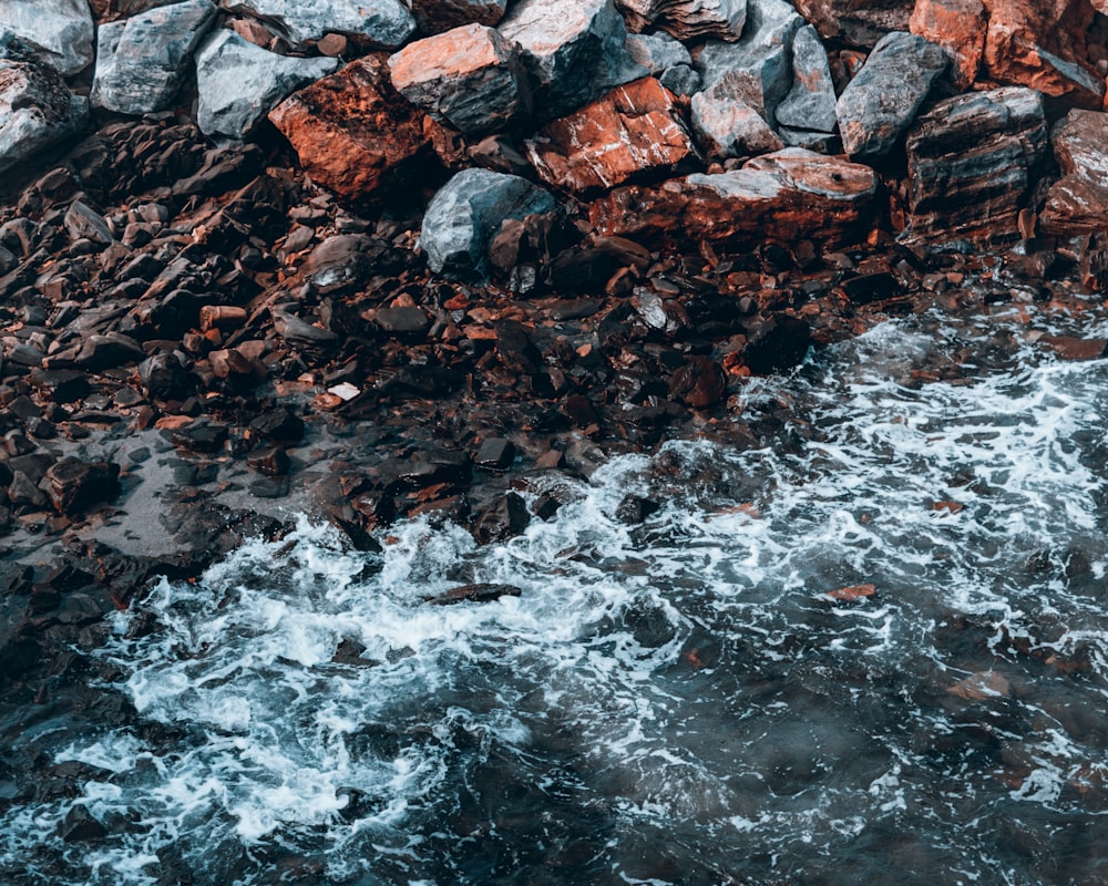 a rocky beach next to a body of water