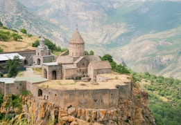 an old church perched on top of a cliff