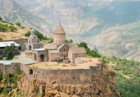 an old church perched on top of a cliff