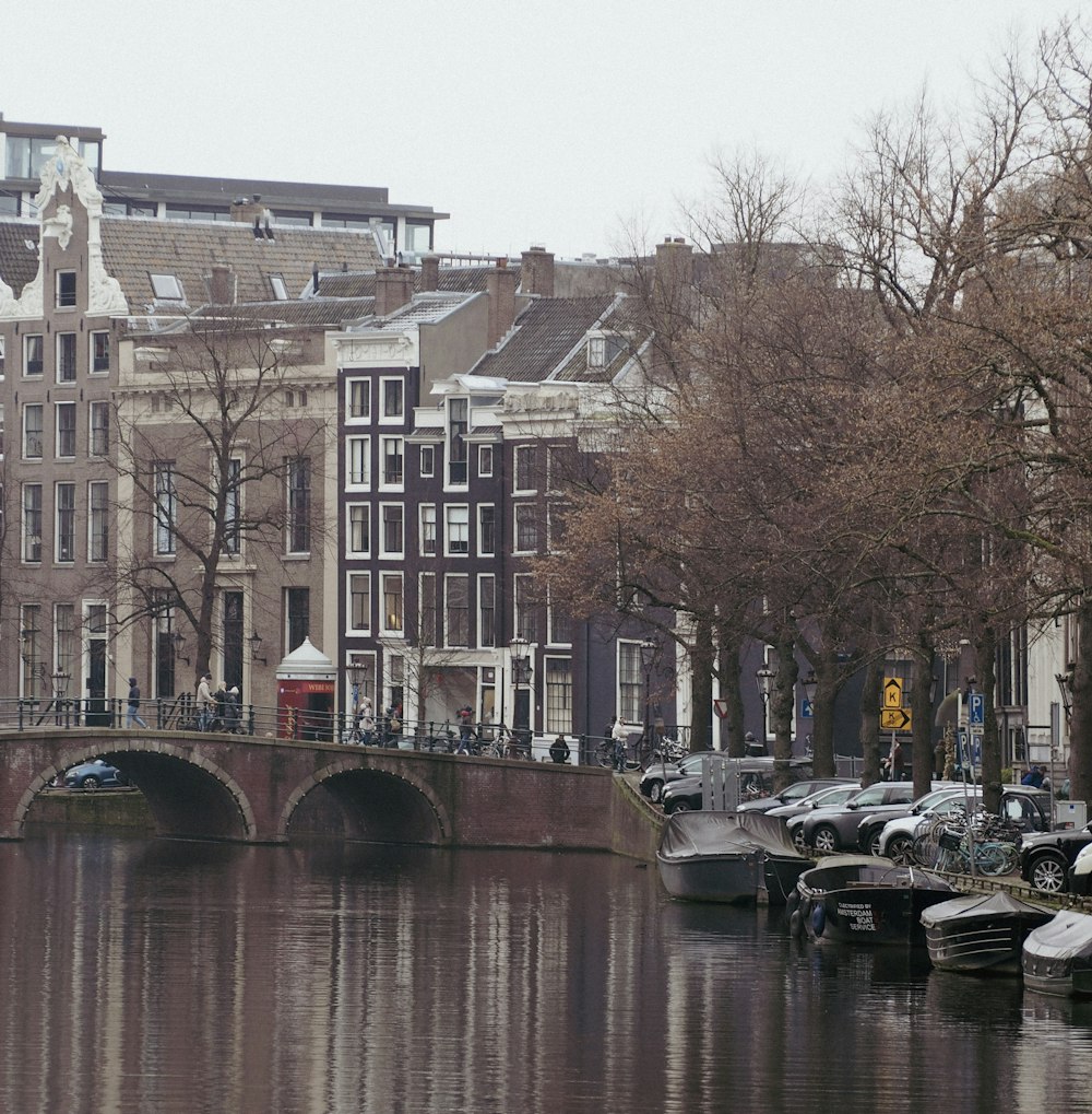 a bridge over a body of water next to a row of buildings