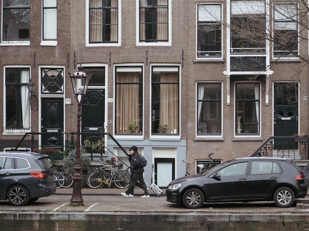 a couple of cars parked in front of a building