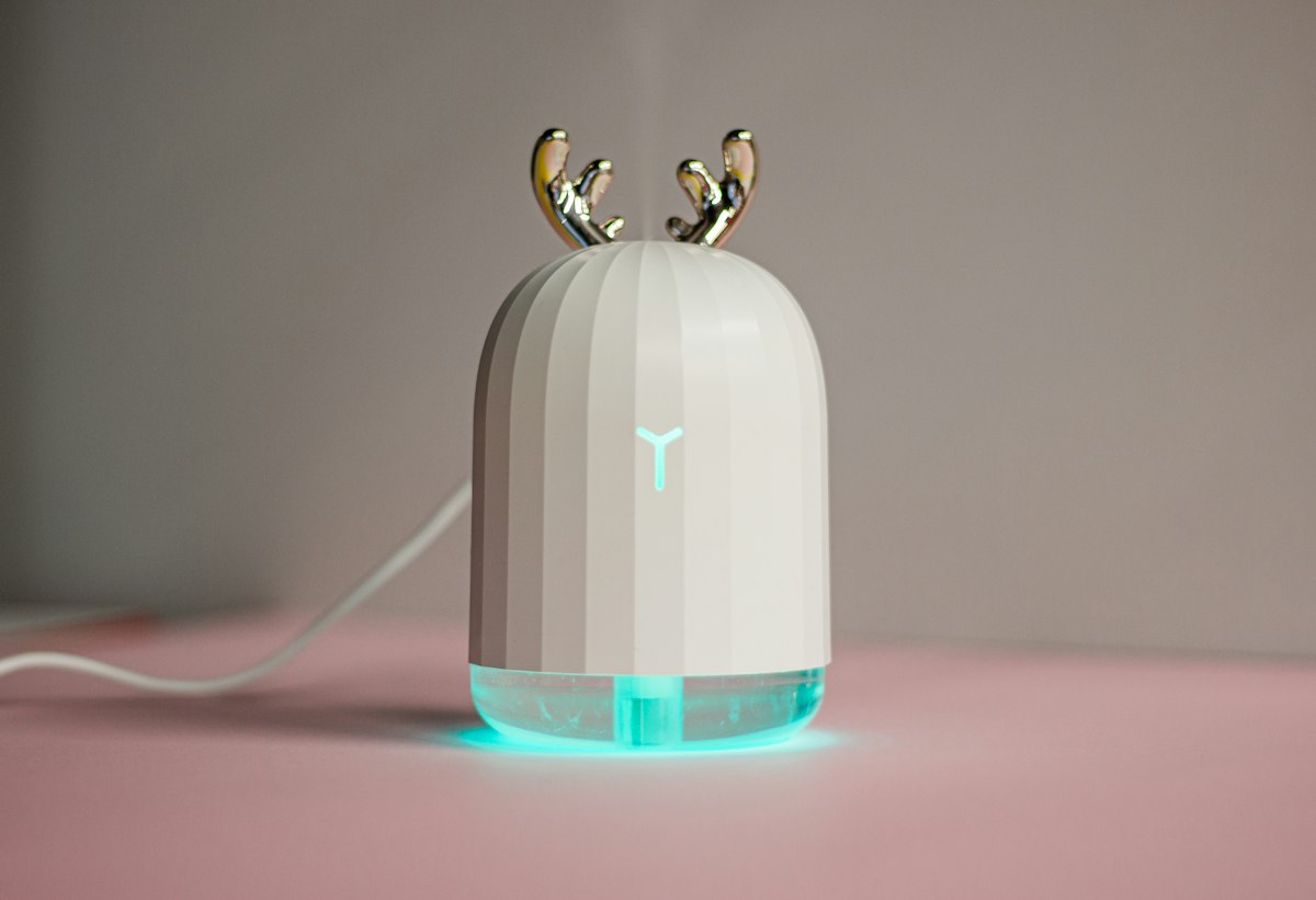 White humidifier on a shelf with decor