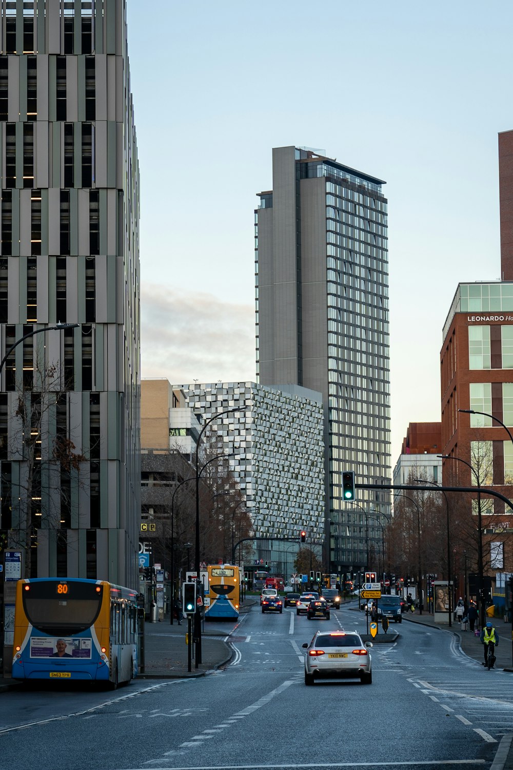 a city street filled with traffic next to tall buildings