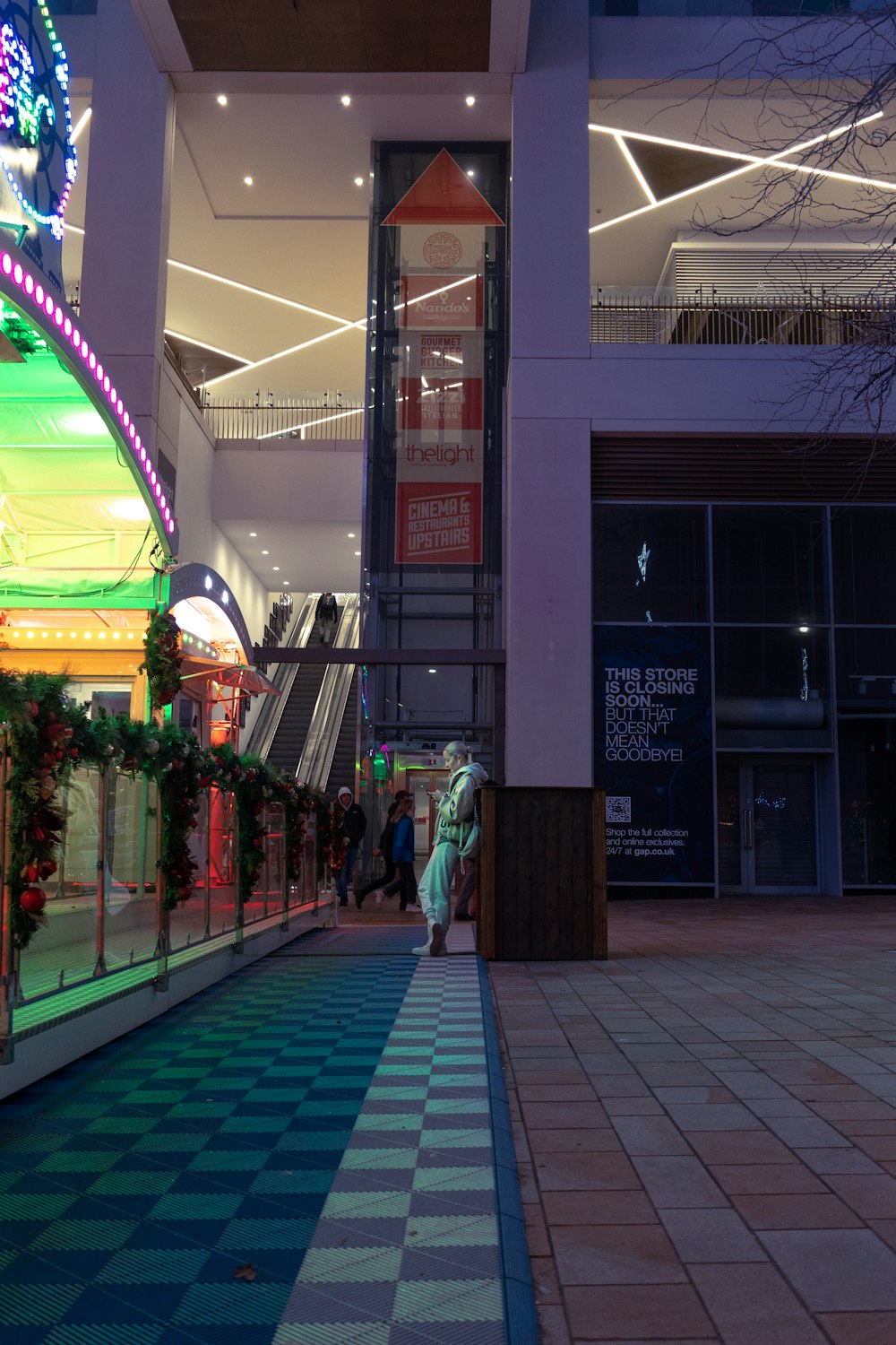 a shopping mall with christmas decorations and lights