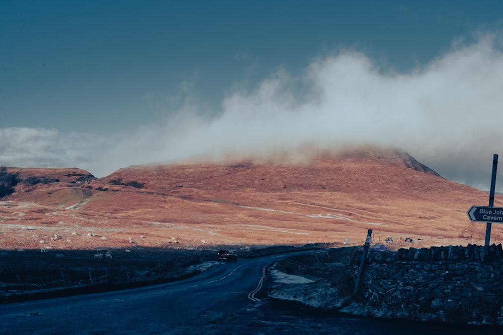 a road with a mountain in the background