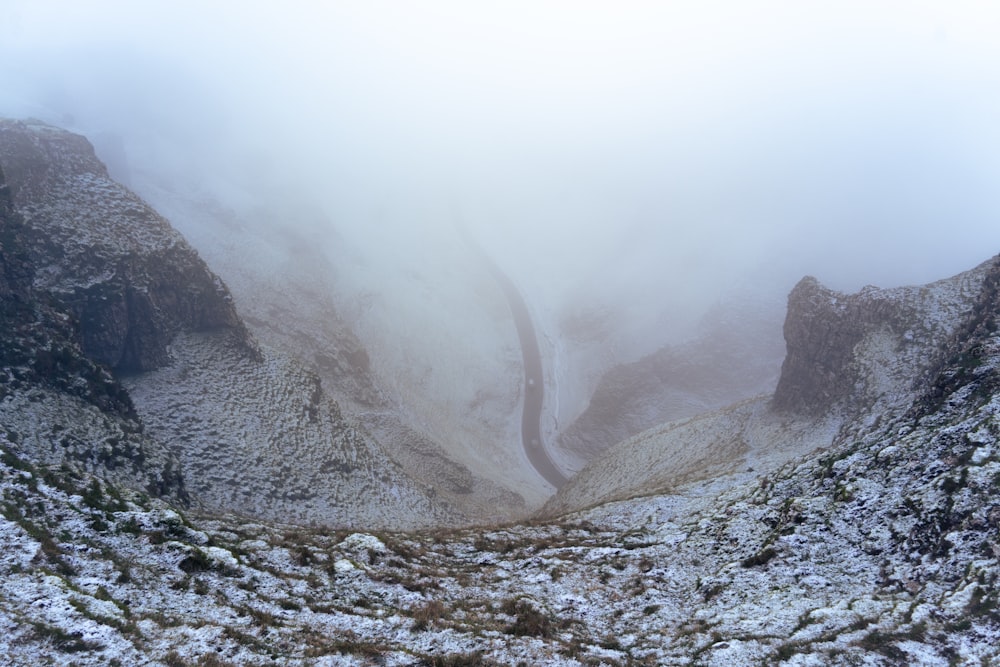 a view of a snowy mountain with a road going through it