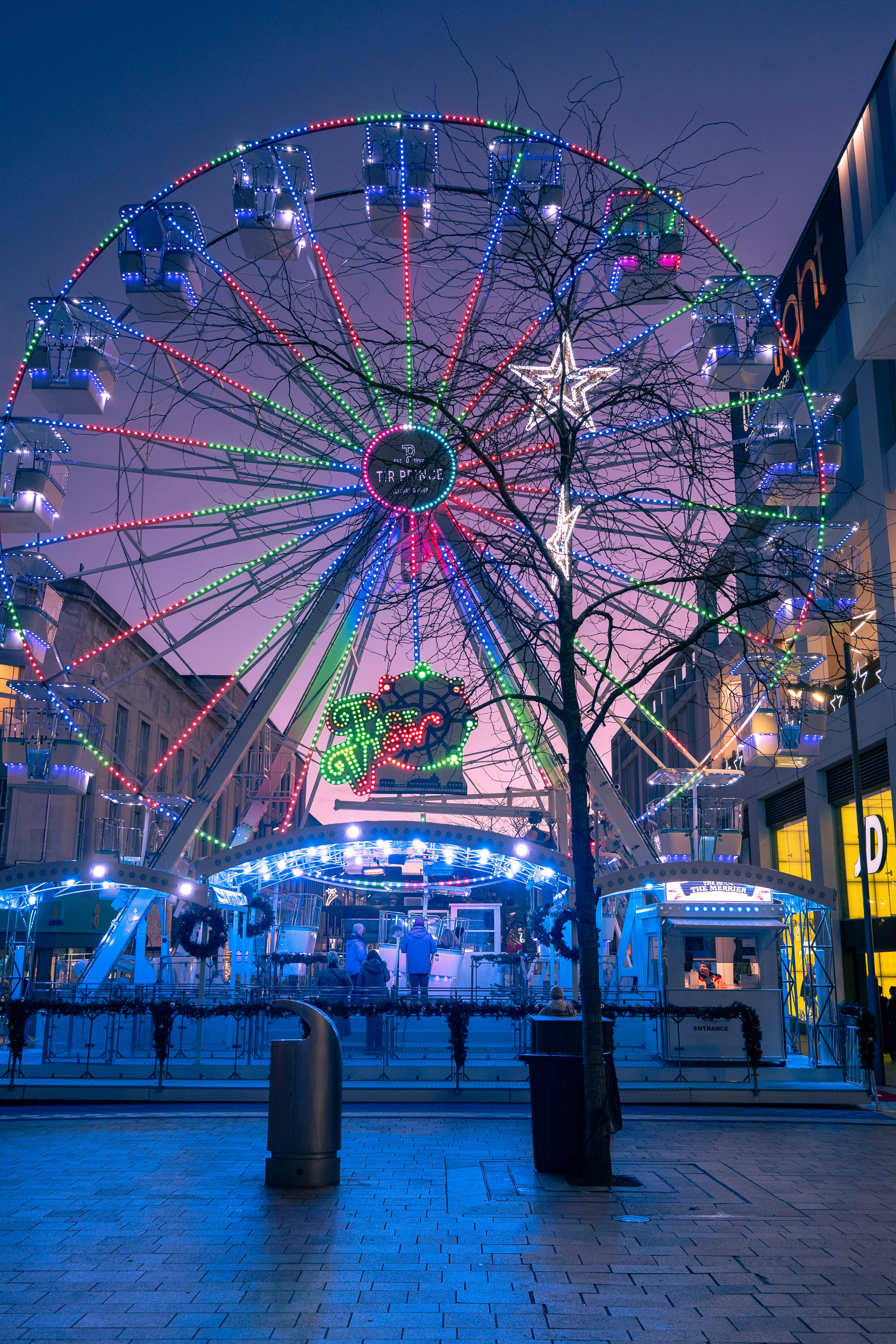 a ferris wheel is lit up at night