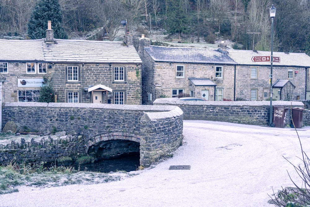 a stone bridge over a small stream in a village