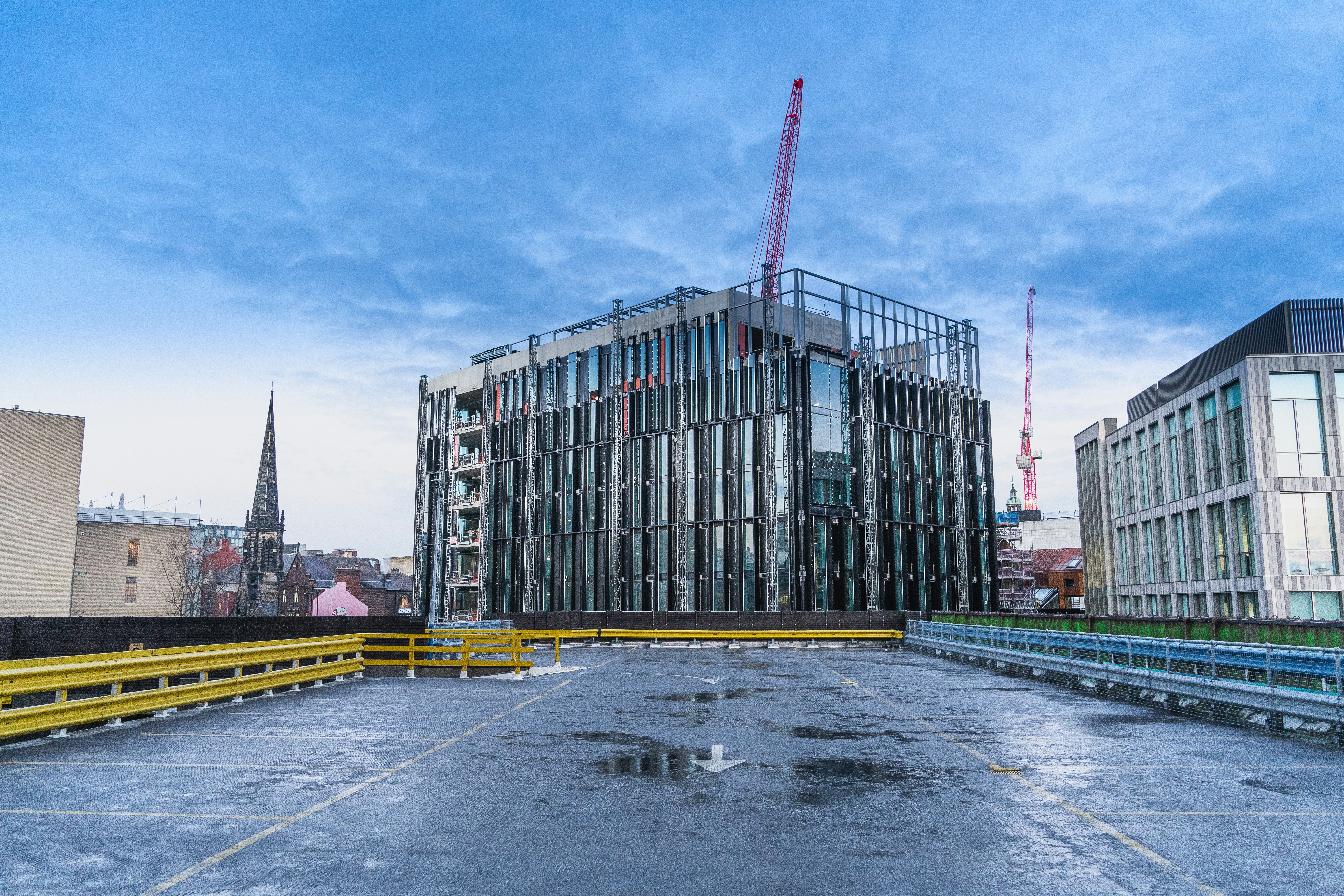 an empty parking lot with a building in the background