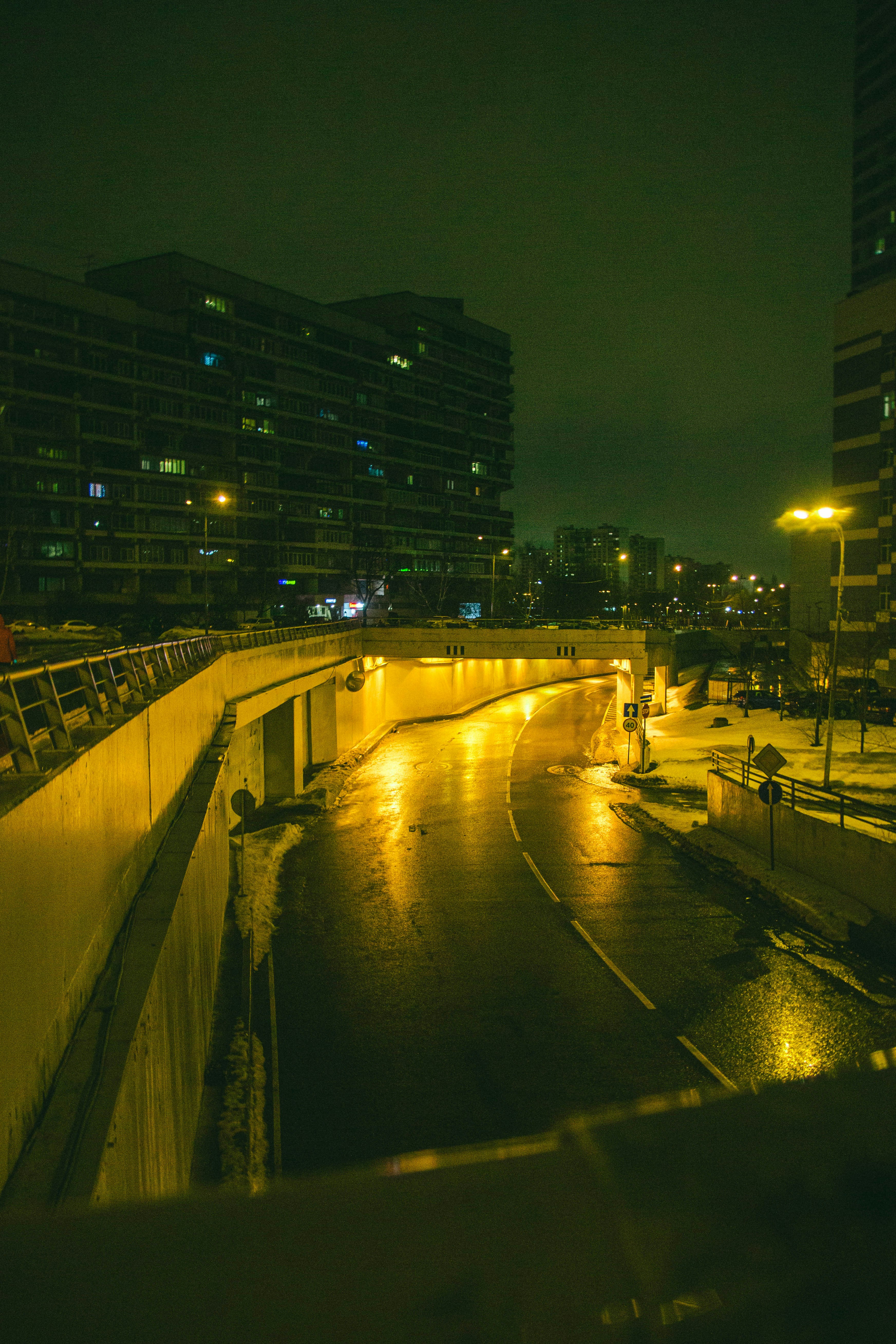 a city street at night with rain on the ground