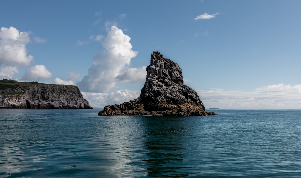 a large rock sticking out of the ocean