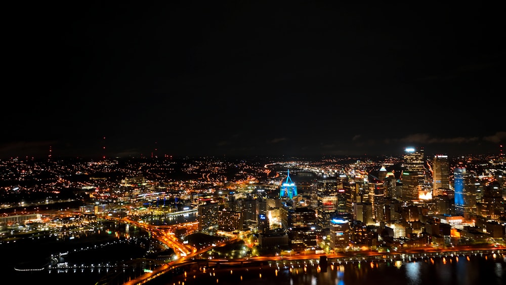 a view of a city at night from the top of a hill