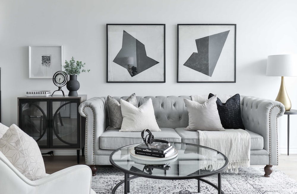 a living room filled with furniture and pictures on the wall