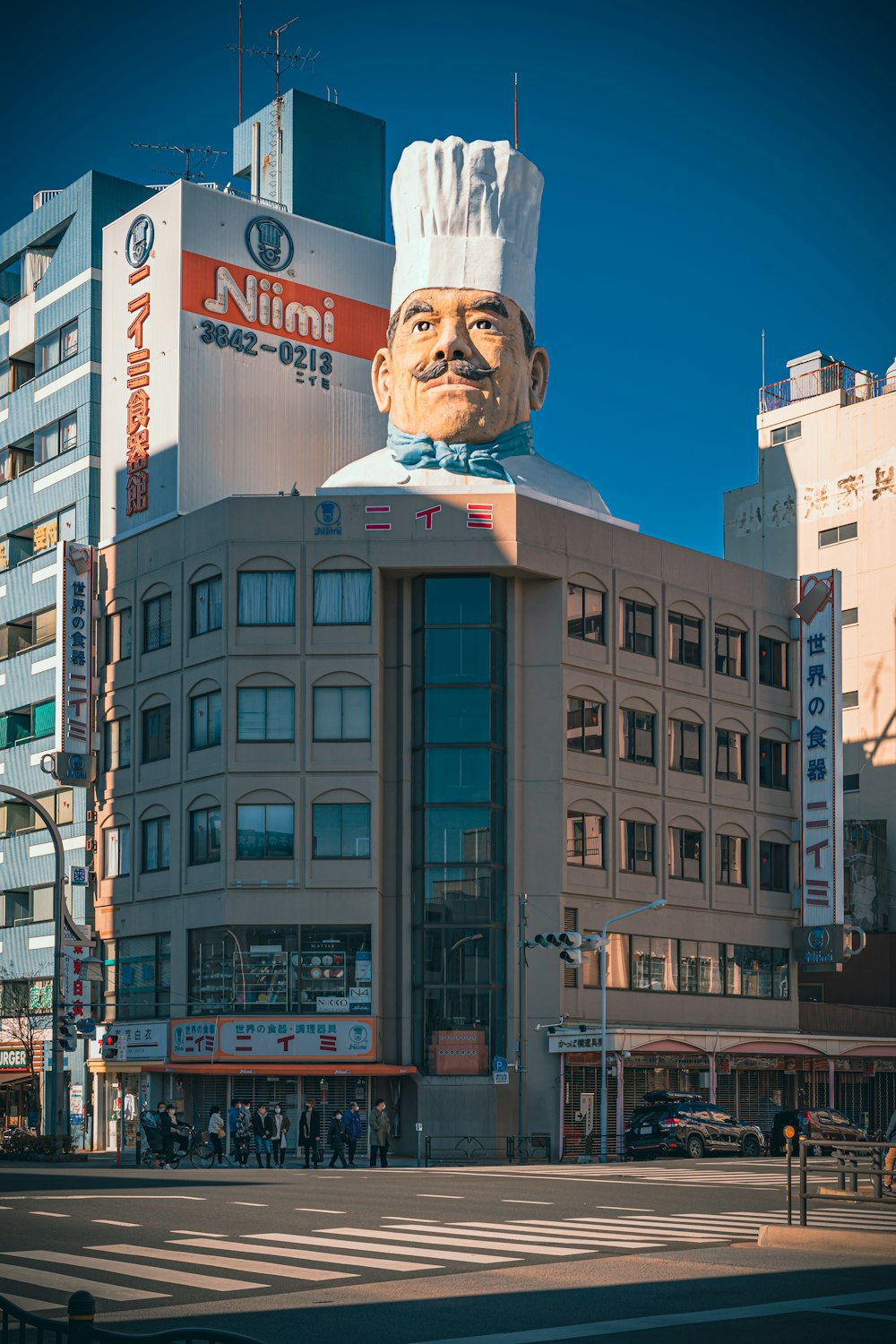 a large statue of a chef on top of a building