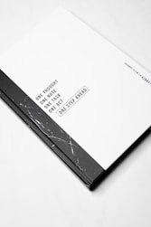 a black and white book on a white surface