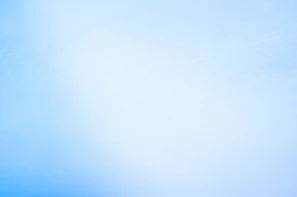 a blurry photo of a blue sky with a plane in the distance