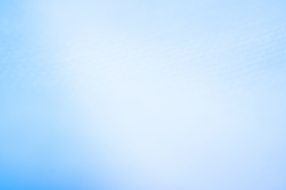 a blurry photo of a blue sky with a plane in the distance