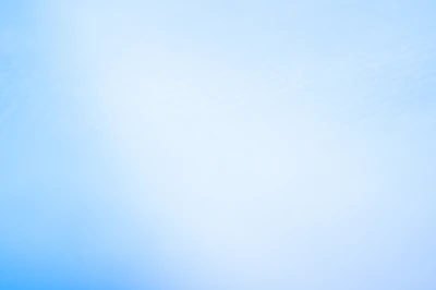 a blurry photo of a blue sky with a plane in the distance