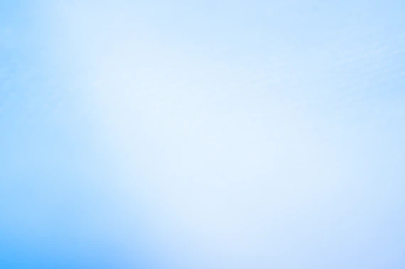 a blurry photo of a blue sky with a plane in the distance