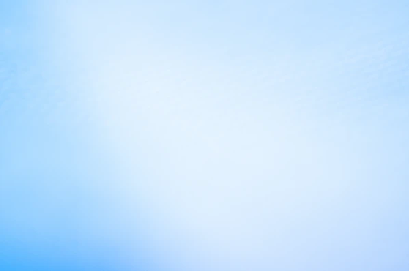 a blurry photo of a blue sky with a plane in the distance
