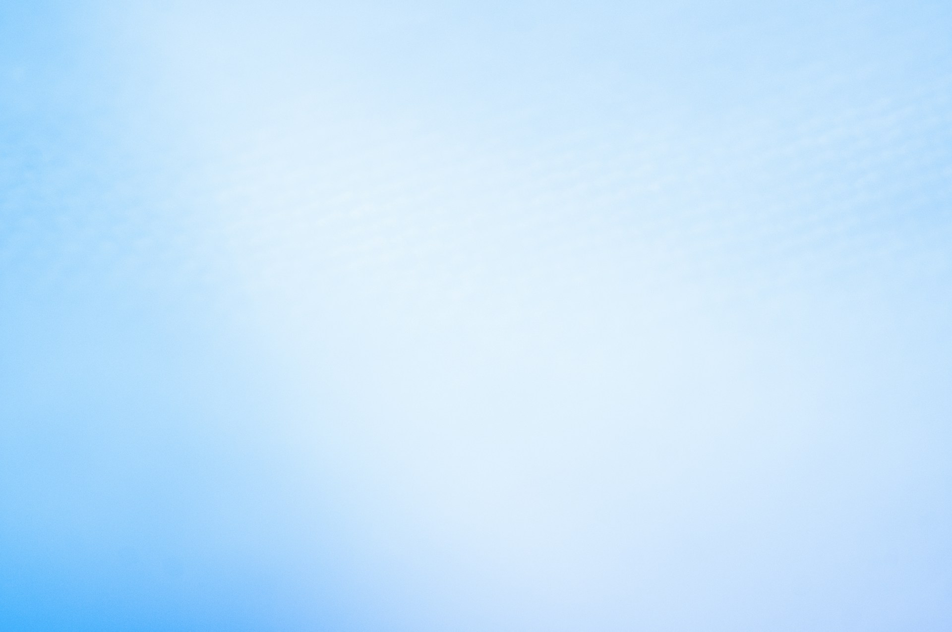 a blurry photo of a blue sky with a plane in the distance