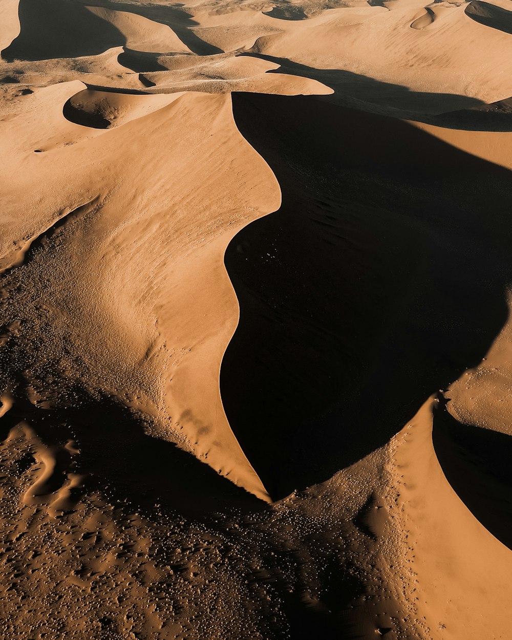 an aerial view of sand dunes in the desert
