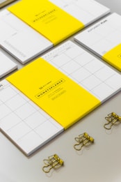 a group of yellow and white binders sitting on top of a table