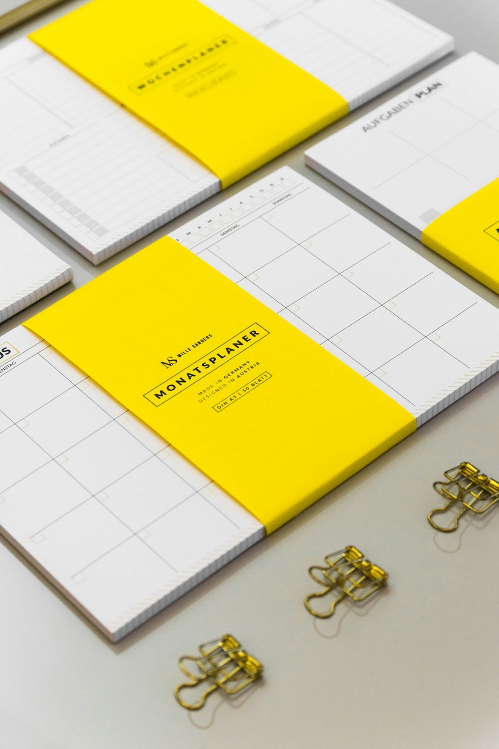 a group of yellow and white binders sitting on top of a table