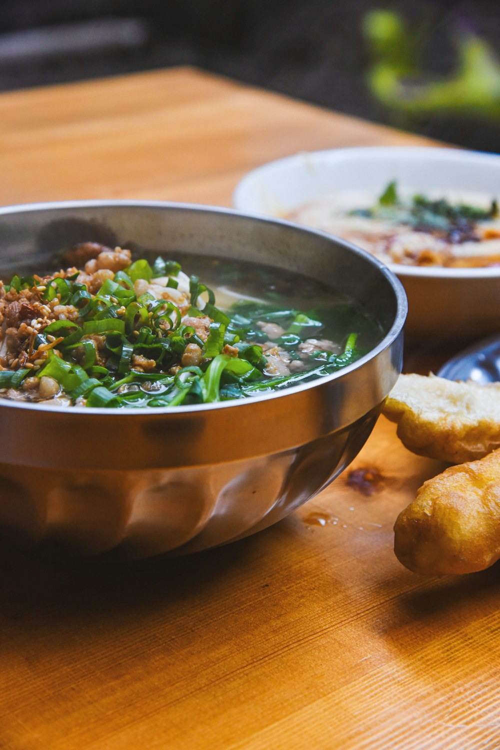 a wooden table topped with bowls of food