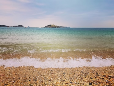 A picturesque beach scene with clear blue waters.