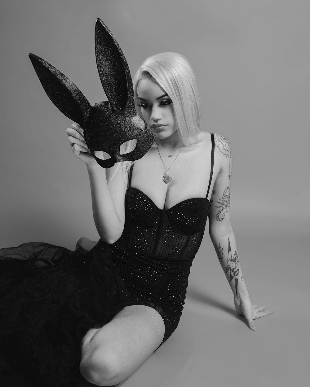 1000px x 1250px - a woman in a black dress holding a mask photo â€“ Free Hand Image on Unsplash