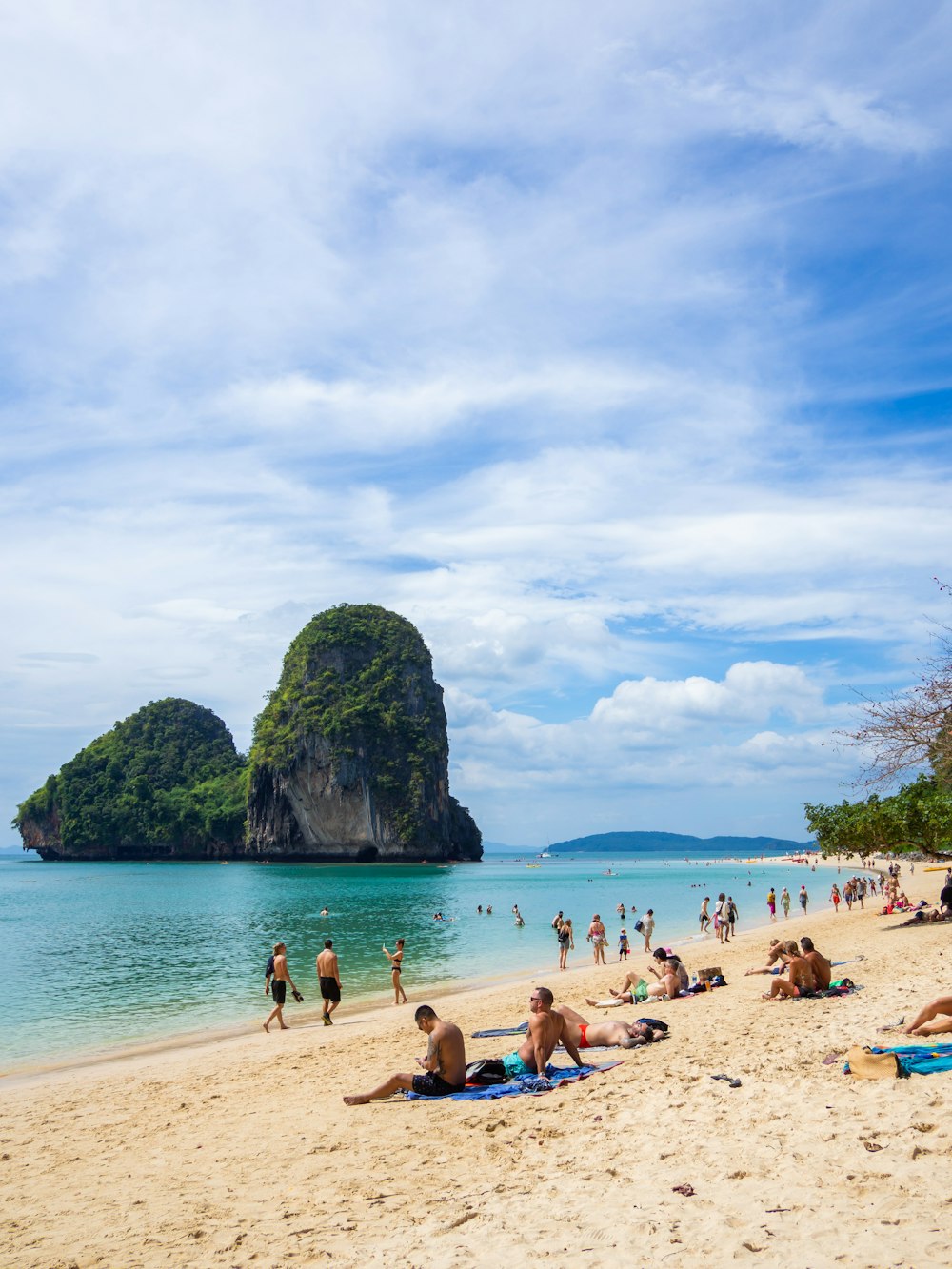 a group of people laying on top of a sandy beach