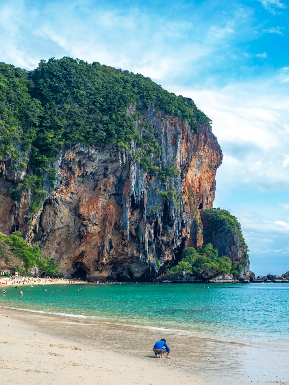 a person sitting on a beach next to the ocean