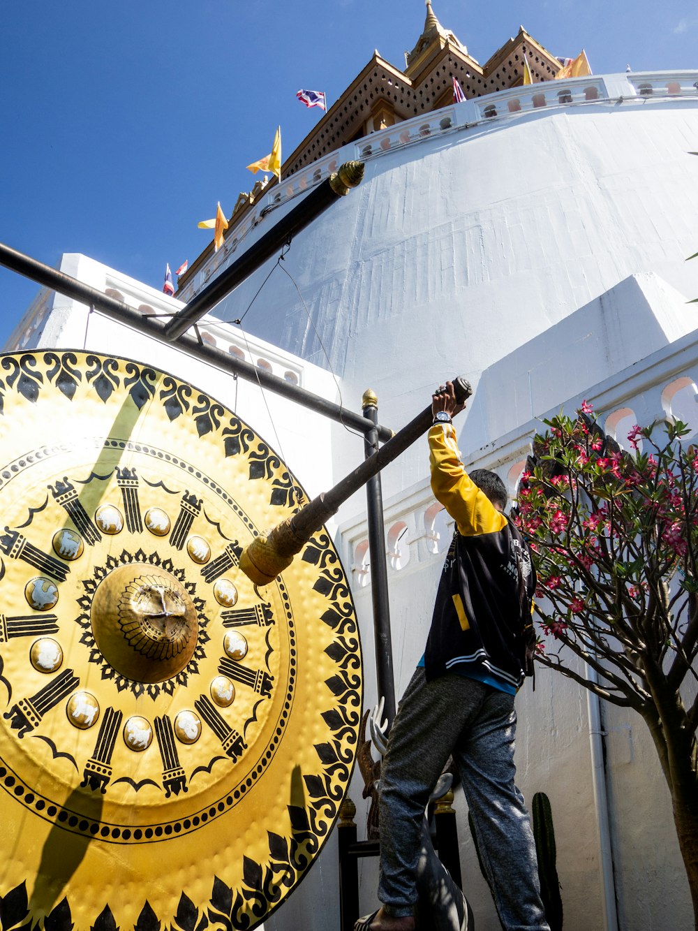 a man standing next to a giant clock