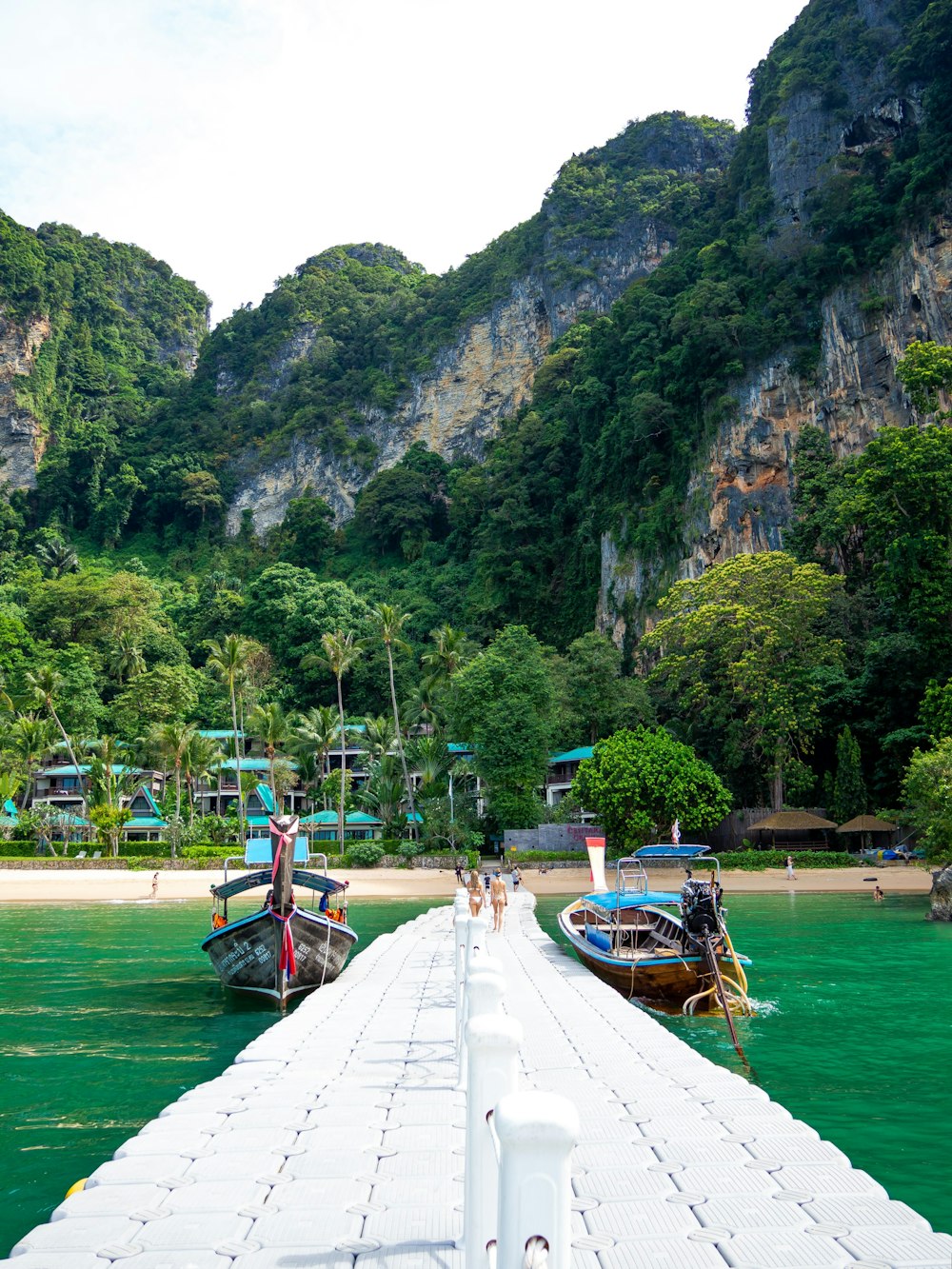 two boats docked at a pier in the water