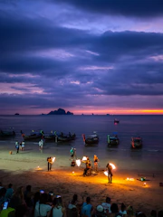 a group of people standing on top of a sandy beach