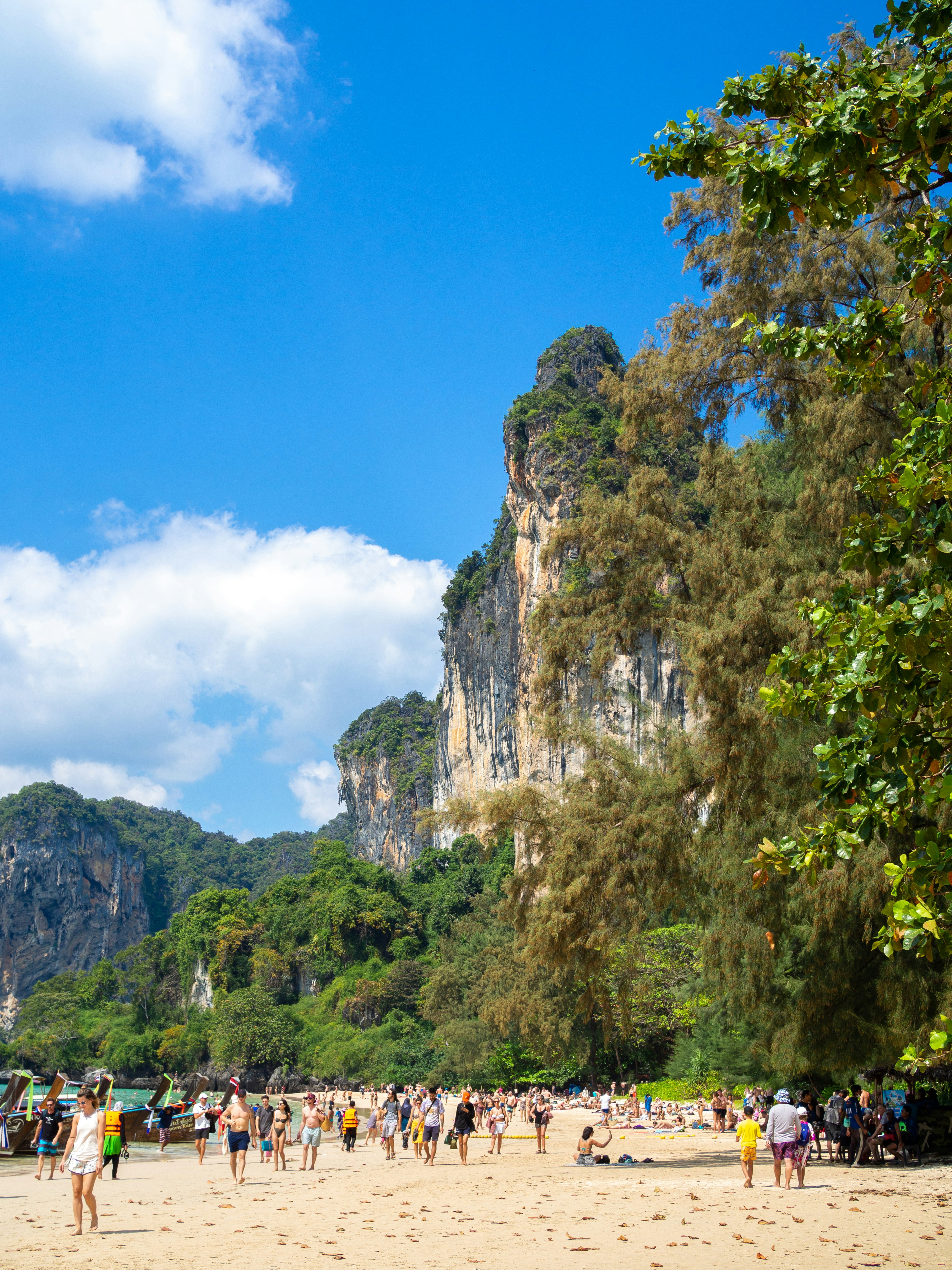 a group of people standing on top of a sandy beach