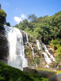 a waterfall with a rainbow in the middle of it
