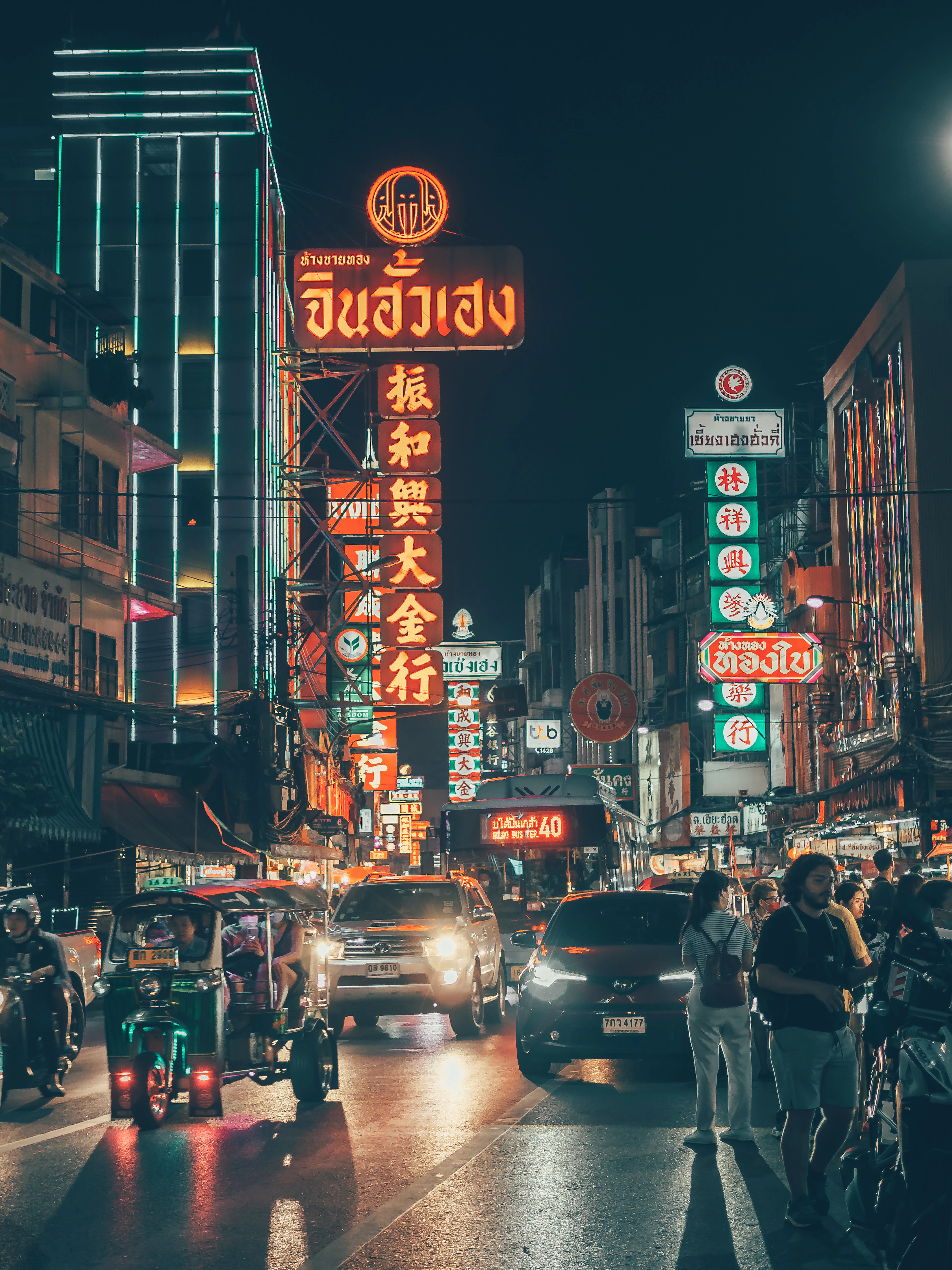 Neon signs and night traffic on Yaowarat Road in Bangkok's Chinatown