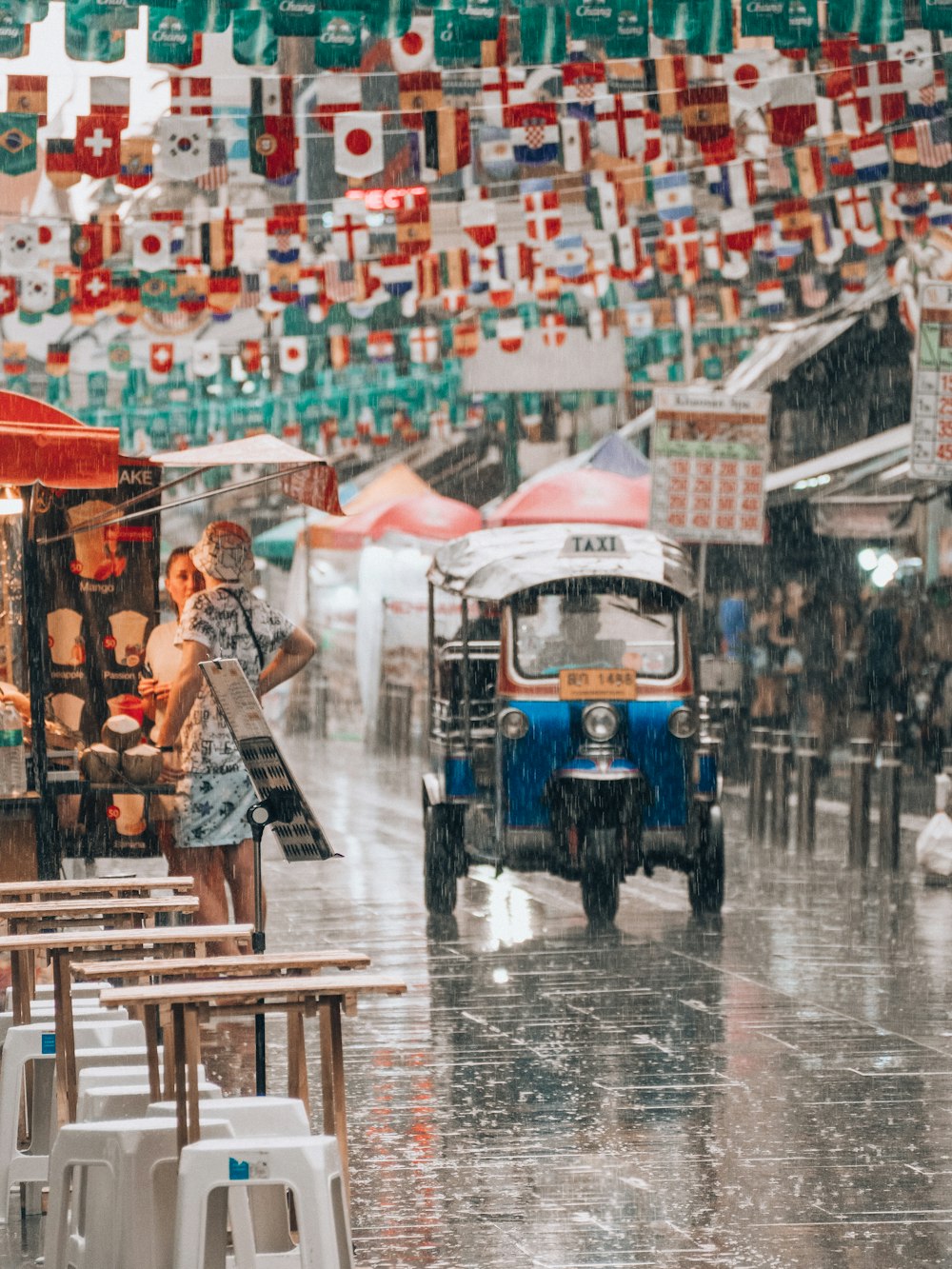 a woman standing under an umbrella in the rain