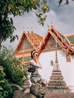 Model wearing a Vixtta jacket standing in front of an ancient temple wall.