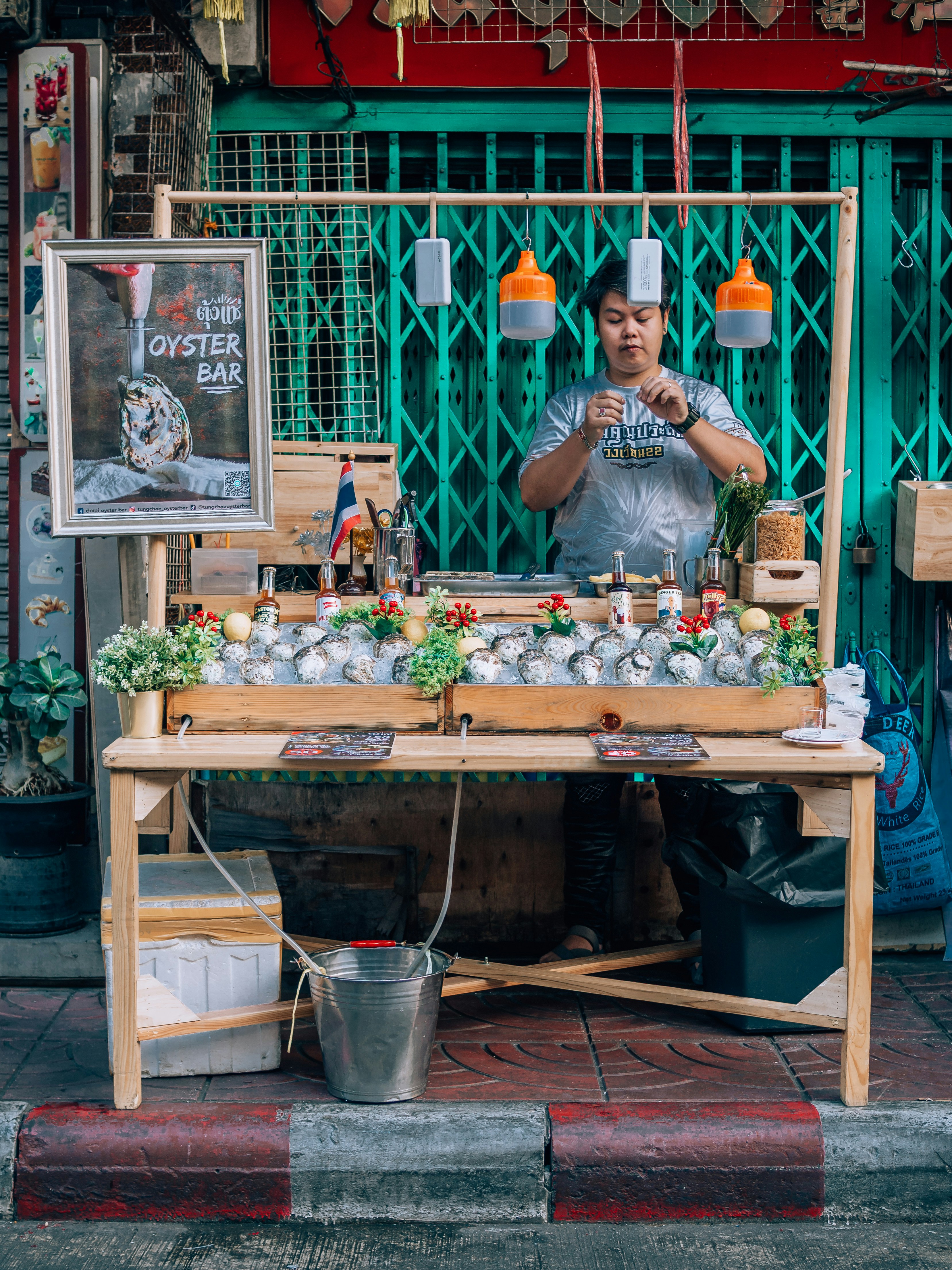 a man standing behind a table filled with food