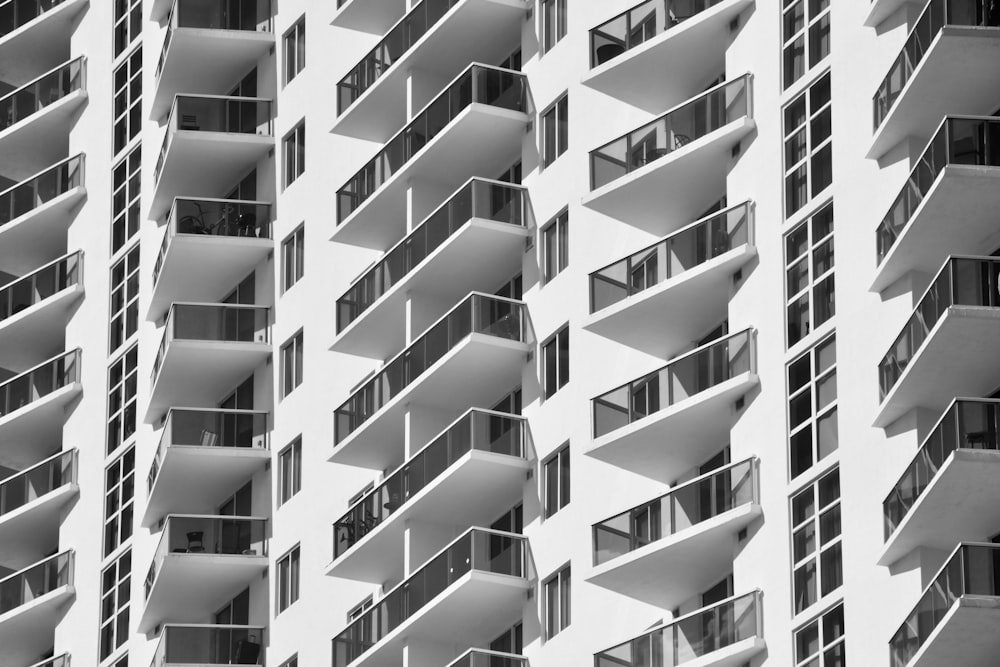 a tall white building with balconies and balconies