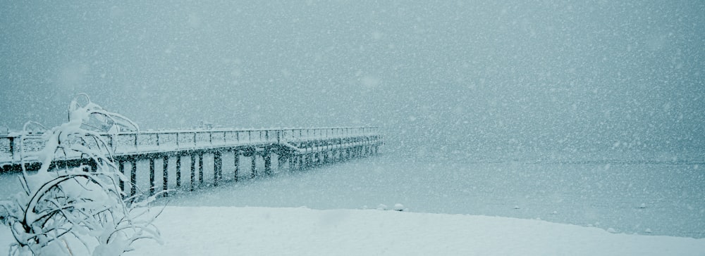 a snow covered pier on a snowy day