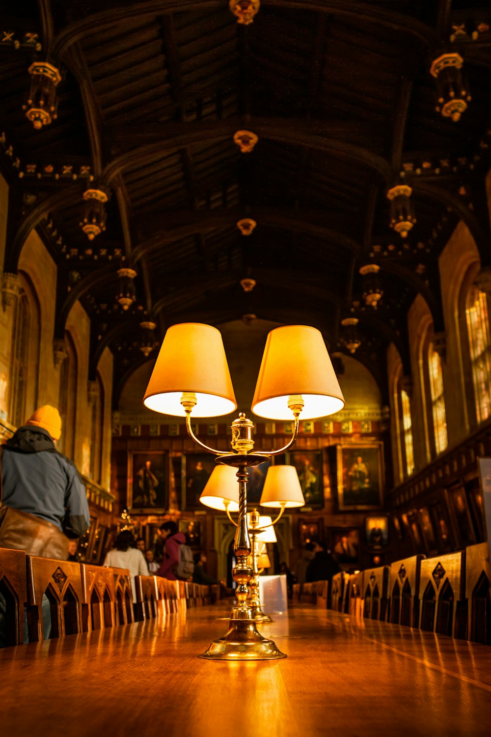 a long table with two lamps on top of it