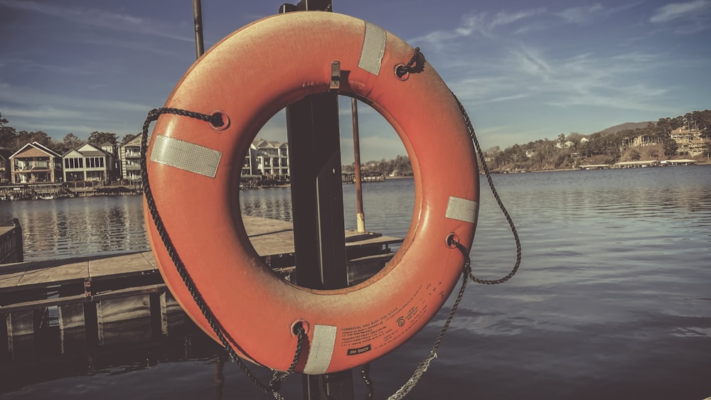 a life preserver sitting on a dock next to a body of water