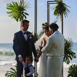 a man and a woman holding hands at a wedding ceremony