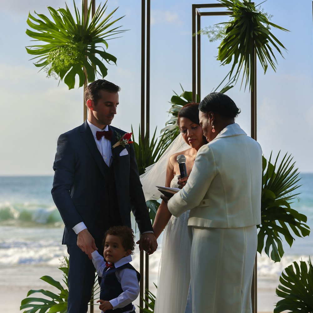 a man and a woman holding hands at a wedding ceremony