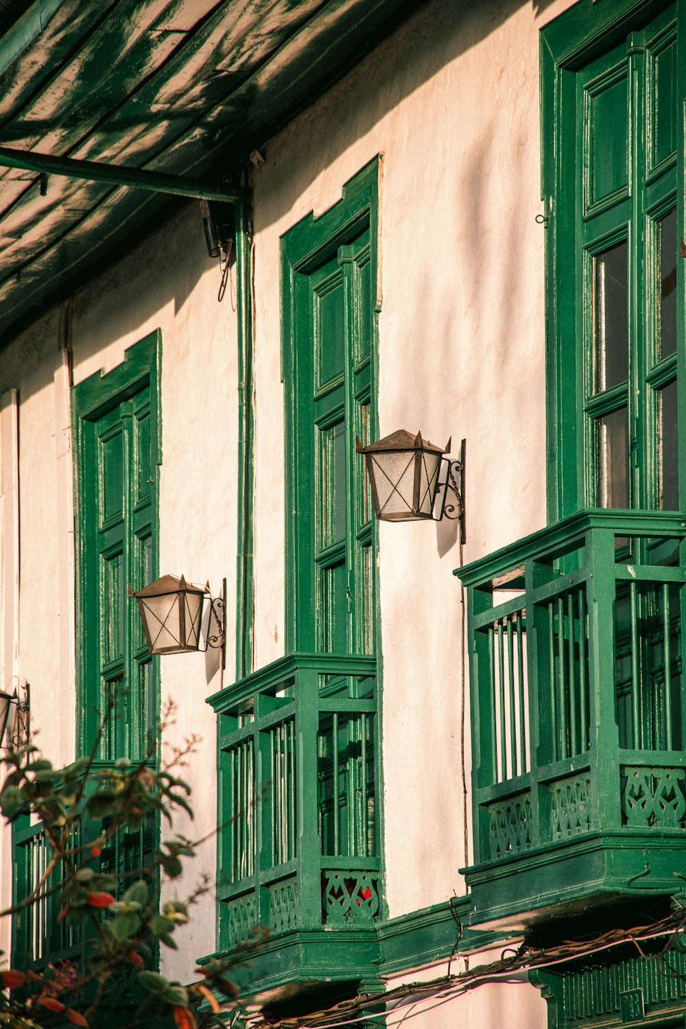 a building with green windows and green shutters