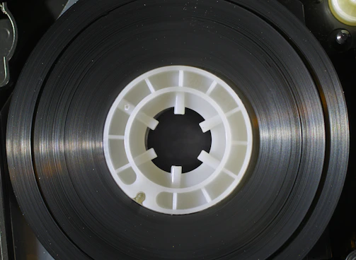 Plastic carrier tape unspooling from a large reel in a manufacturing environment